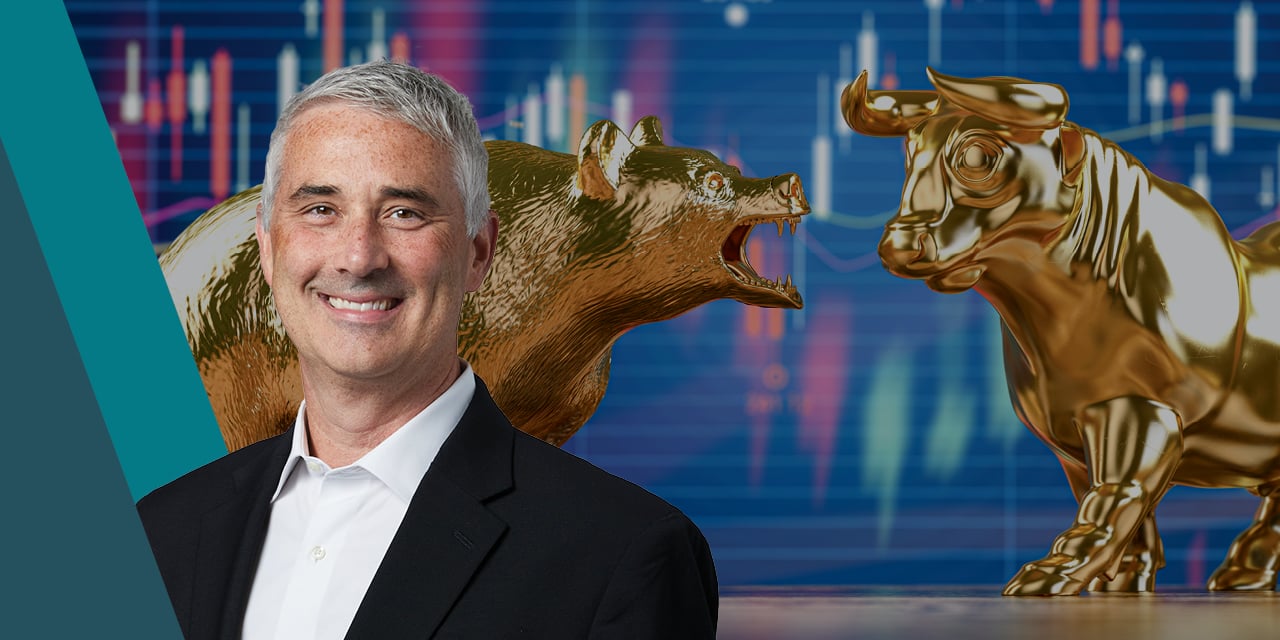 Headshot of Michael Antonelli with statues of a bear and a bull in the background. 