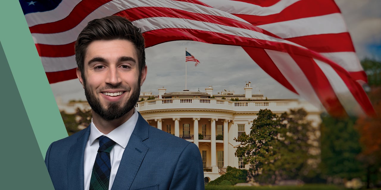 Headshot of Ross Mayfield with a government building and an American flag in the background