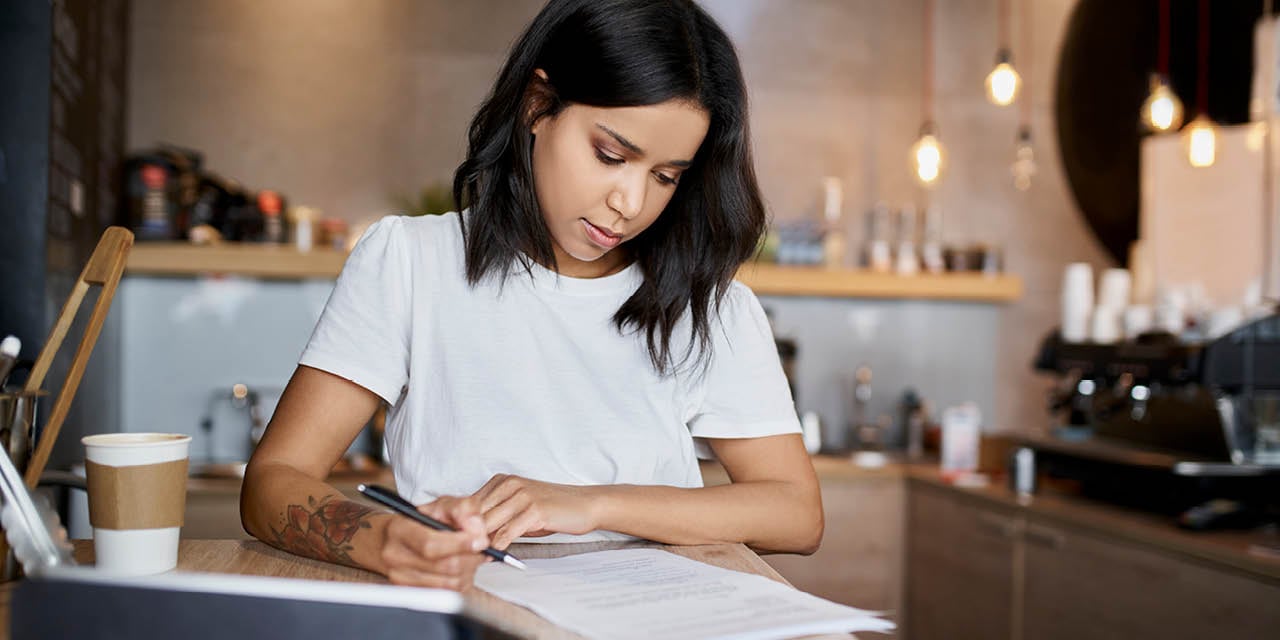 Small business owner reviewing paperwork.