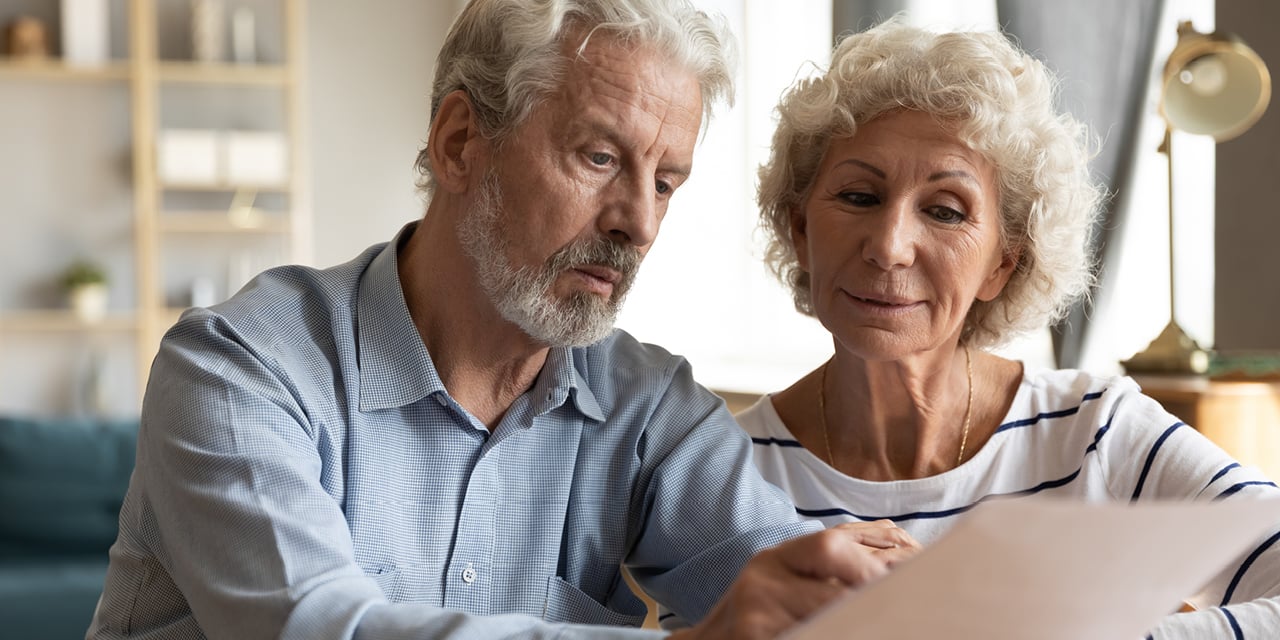 estateplng mature couple reviewing paperwork
