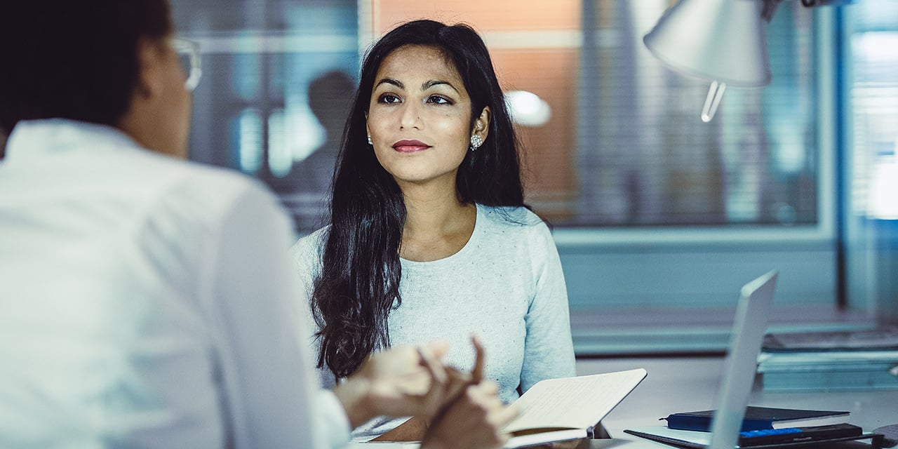 Two women having a meeting in an office setting.