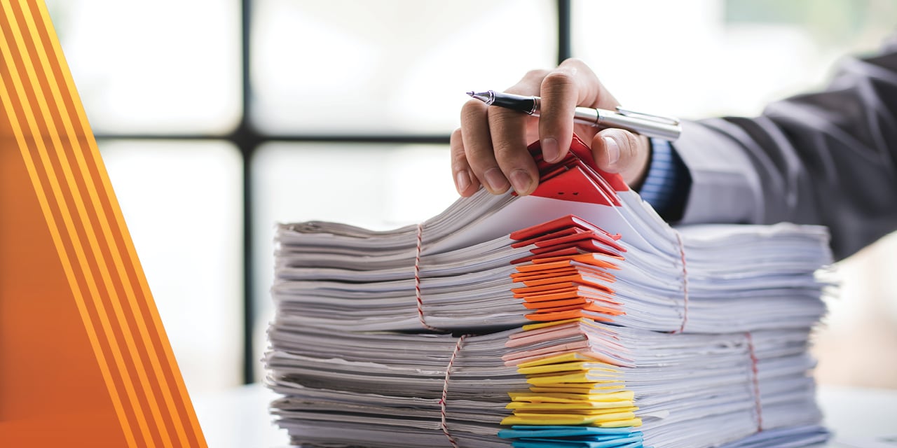 Stack of paperwork on a desk.