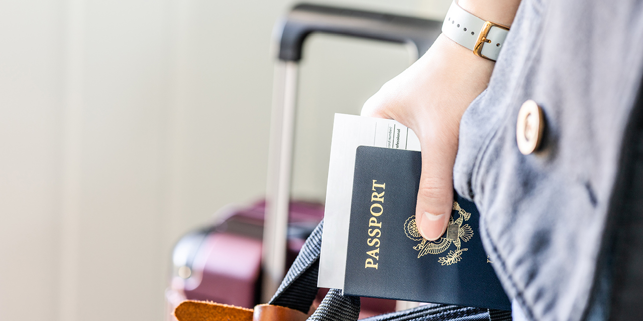 Hand holding a US passport book 