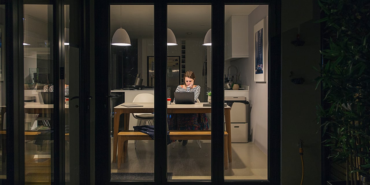 Women working as a desk in her home.