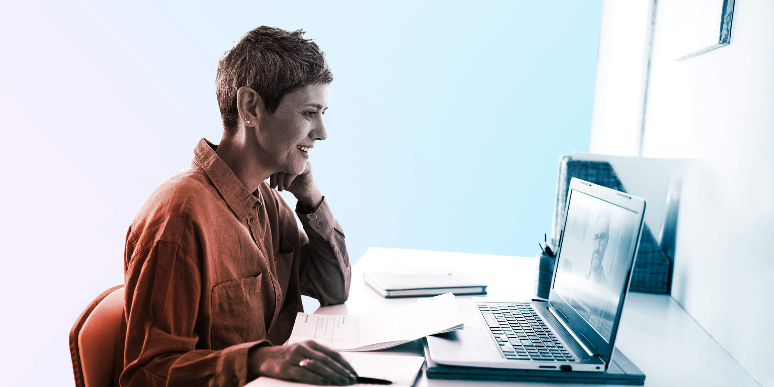 Woman following online courses on her laptop at home