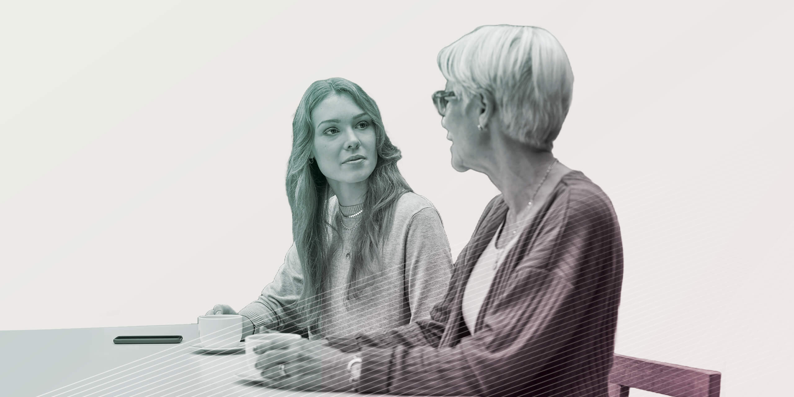 Mother and adult daughter talking at table