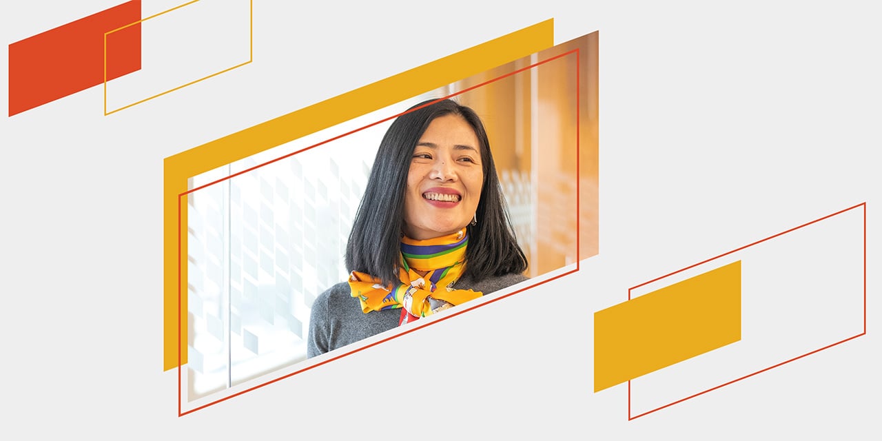Orange and yellow parallelograms framing a smiling Baird associate
