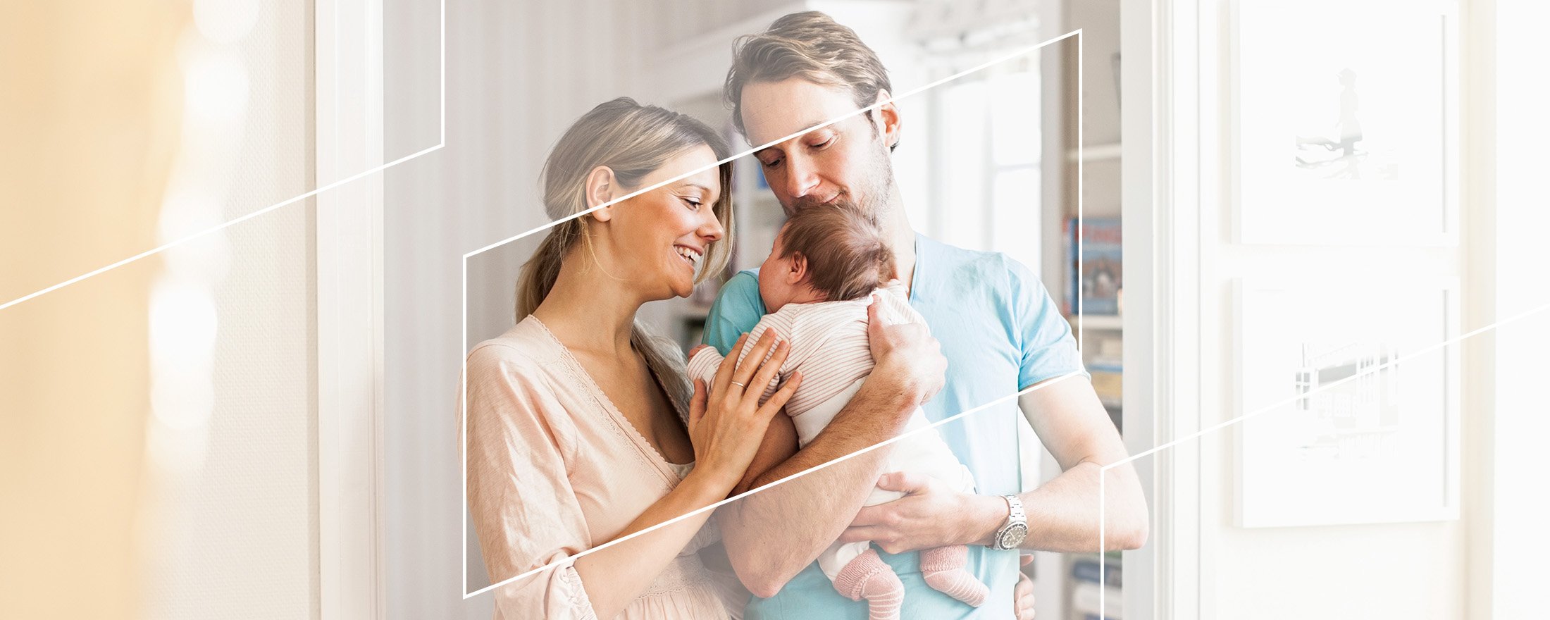 two new parents cradling an infant