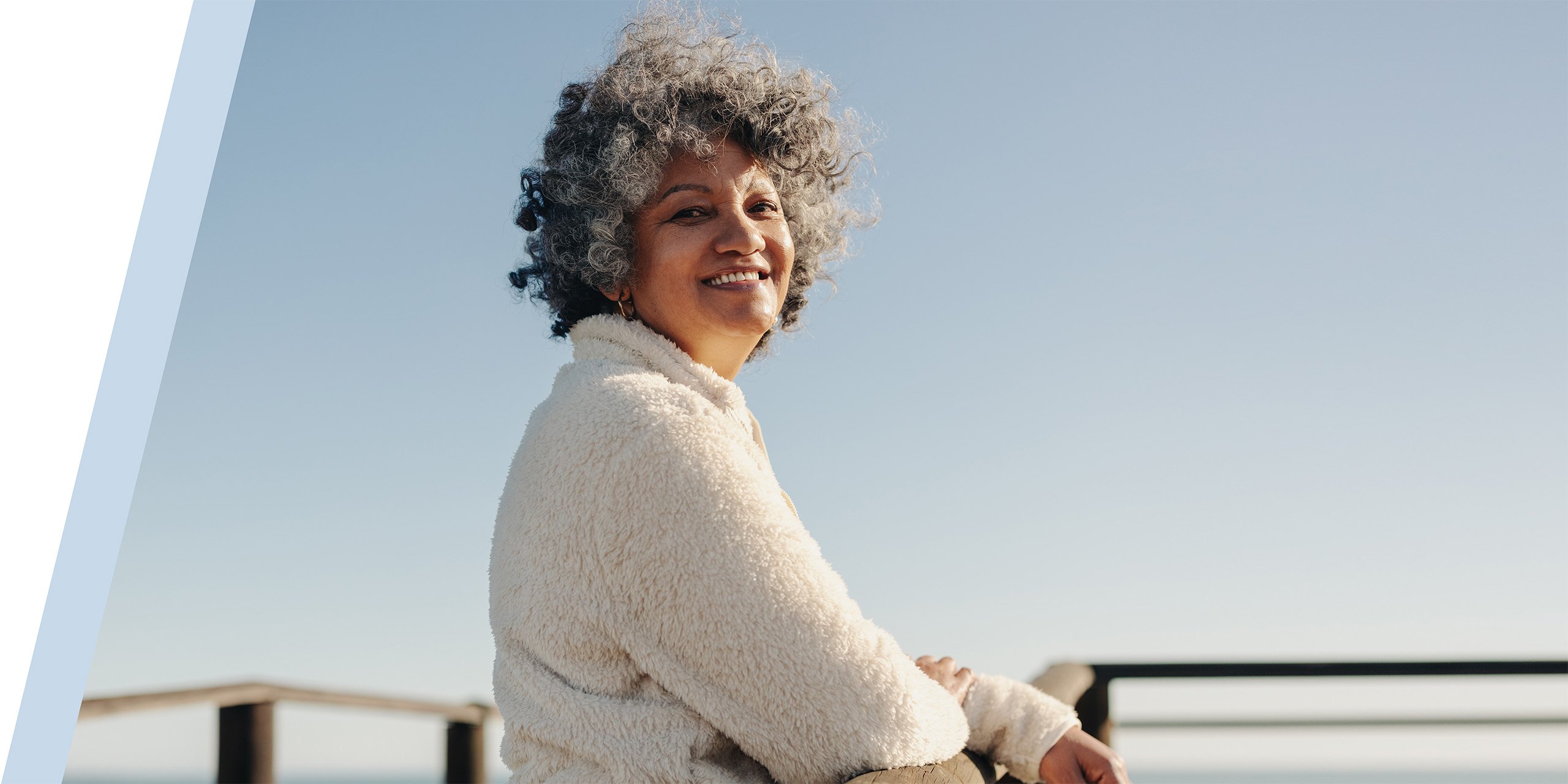 woman standing on pier and smiling